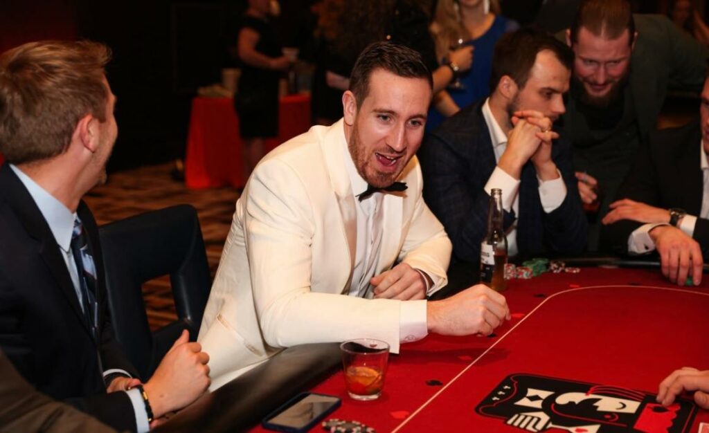 Guests gathered around a casino table at a brand event