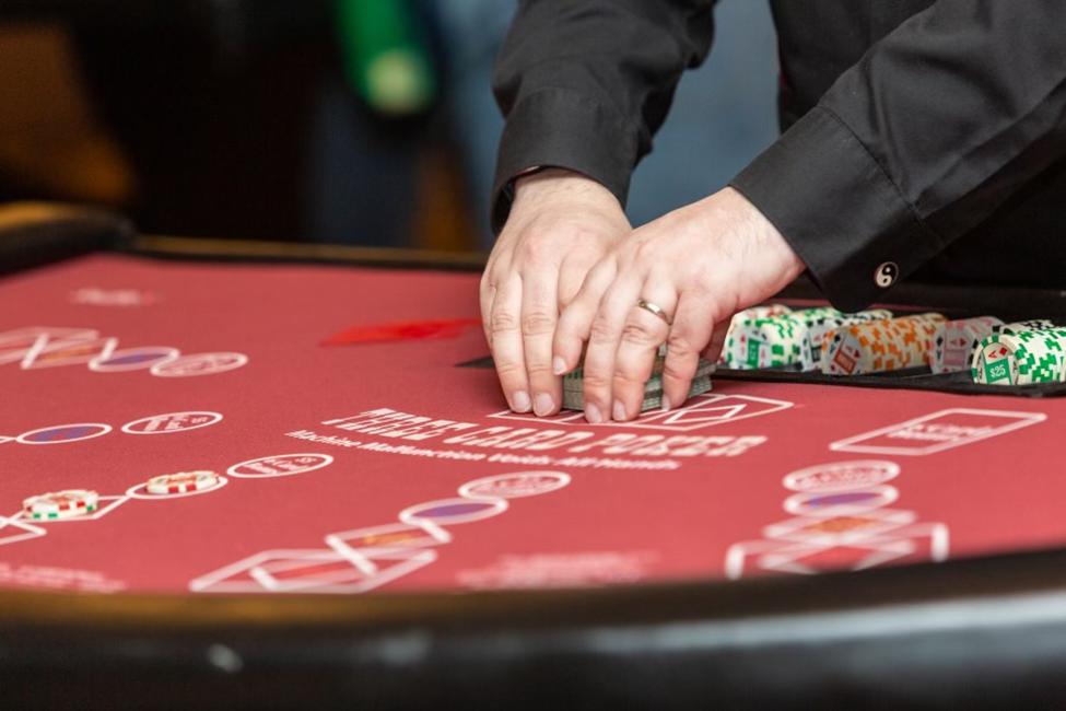 Professional dealer preparing cards and chips for a high-end casino party