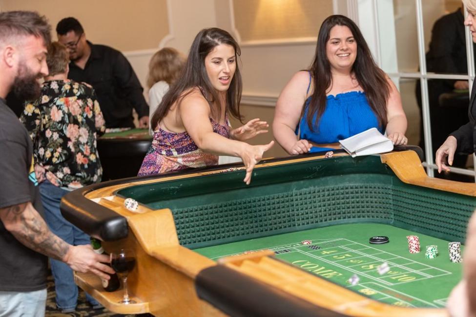 Team members playing craps during an office casino night entertainment event